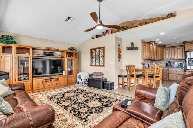 living area with lofted ceiling, light tile patterned floors, ceiling fan, and visible vents