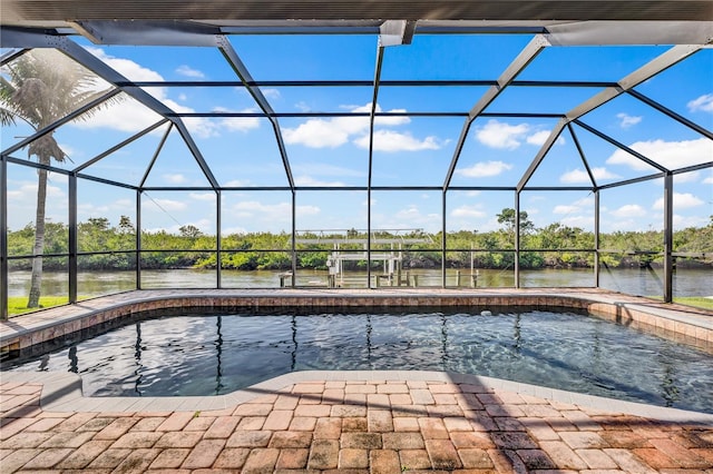 pool with a lanai, a water view, and a patio