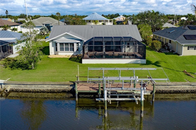 dock area with glass enclosure, boat lift, a water view, a yard, and a residential view