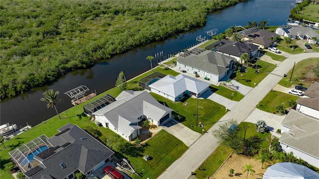 birds eye view of property with a water view and a residential view