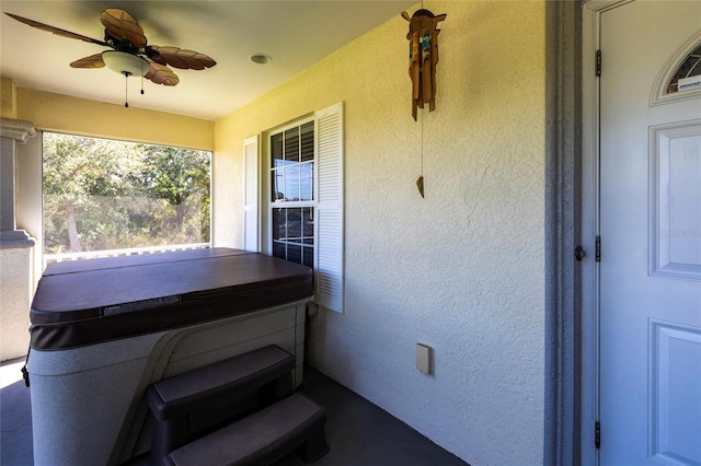 view of patio / terrace with a hot tub and a ceiling fan