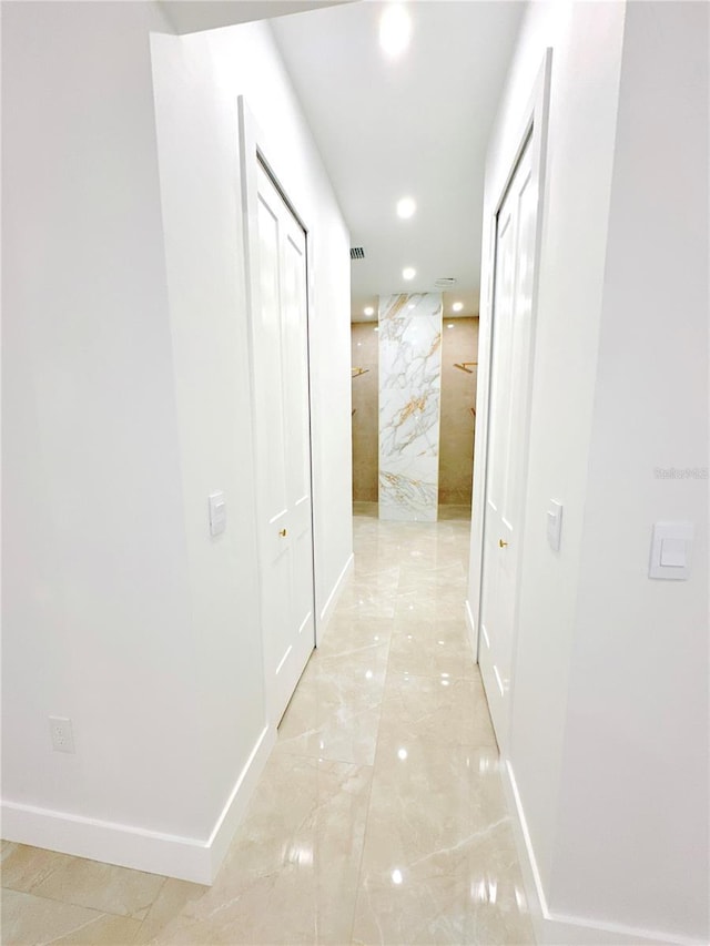 hall with marble finish floor, recessed lighting, visible vents, and baseboards