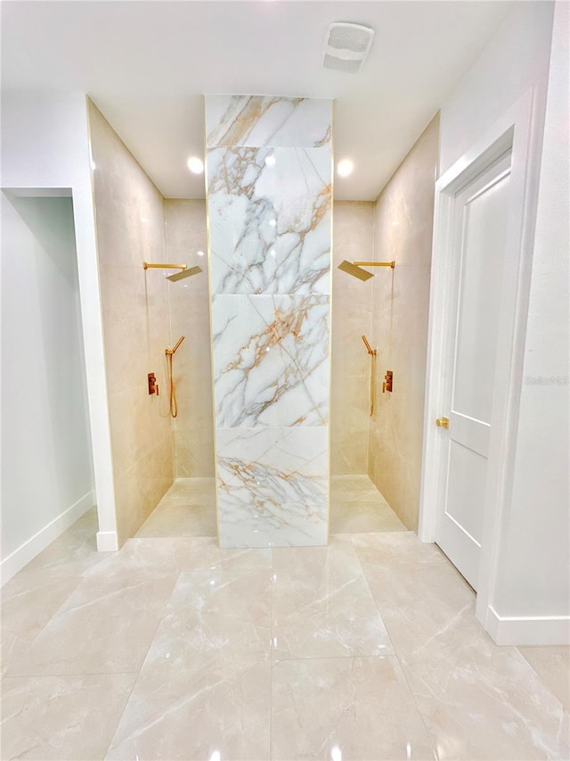 bathroom featuring visible vents and a marble finish shower