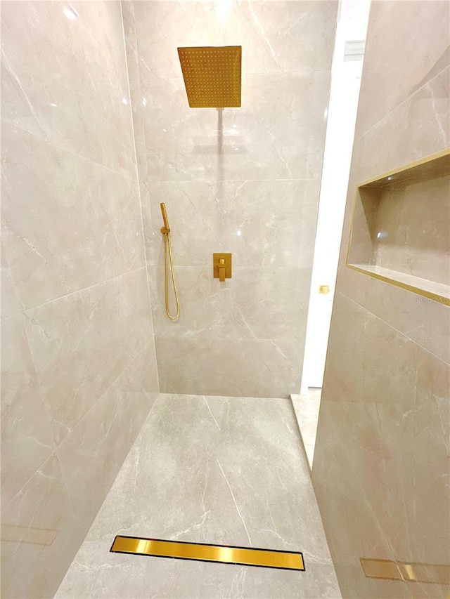 full bath with a tile shower