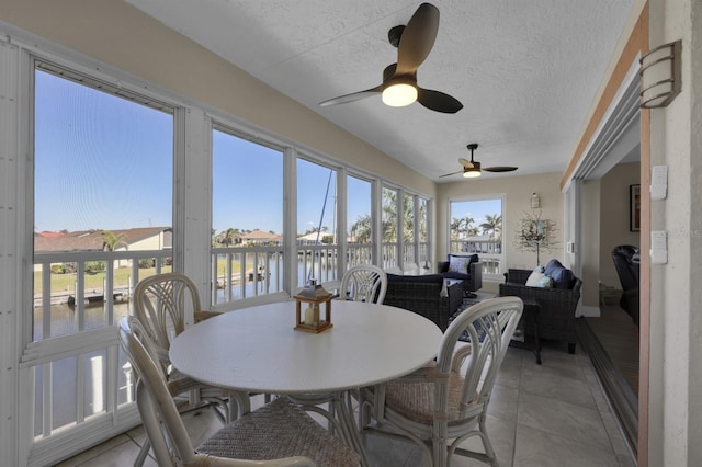 sunroom / solarium featuring a water view