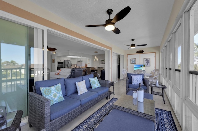 sunroom featuring ceiling fan