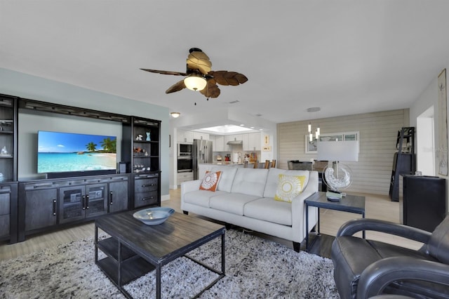 living room featuring light wood-type flooring and ceiling fan