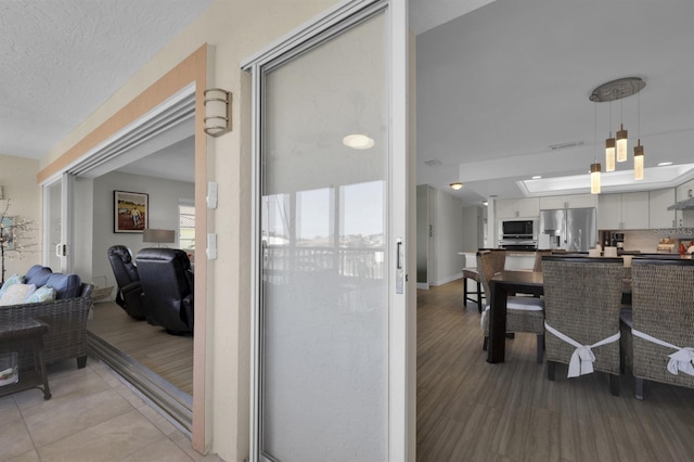 interior space featuring a textured ceiling, visible vents, and baseboards