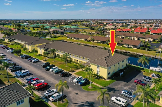 bird's eye view with a water view and a residential view