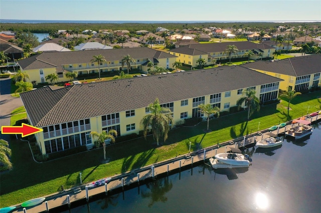 drone / aerial view with a residential view and a water view