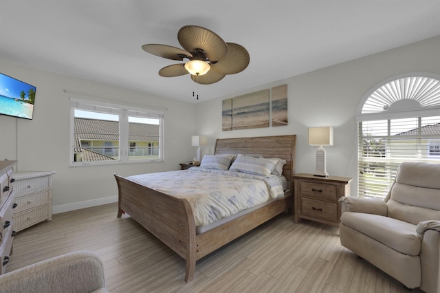 bedroom featuring light wood-type flooring, ceiling fan, and baseboards