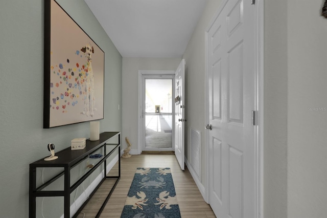 entryway with light wood-style floors and baseboards