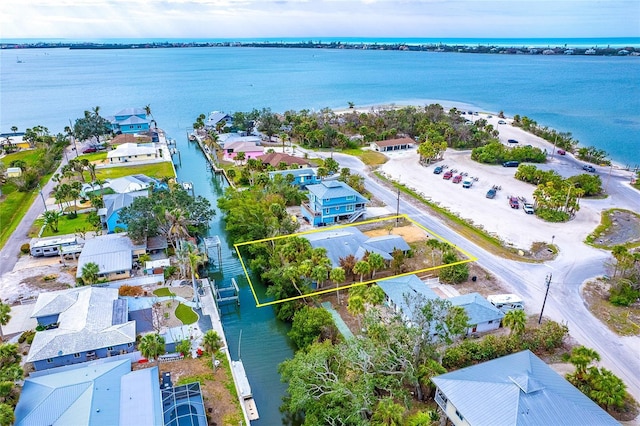 birds eye view of property with a water view and a residential view