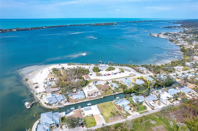 birds eye view of property with a water view and a view of the beach