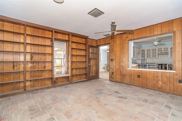 unfurnished room featuring visible vents and wooden walls