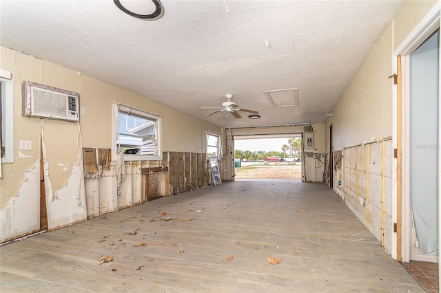 garage with ceiling fan and a wall mounted AC