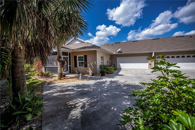 view of front of property featuring a garage, driveway, and stucco siding