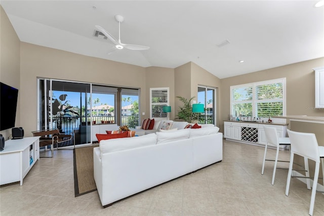 living room with light tile patterned floors, ceiling fan, visible vents, and a wealth of natural light