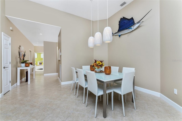 dining area featuring light tile patterned floors, baseboards, and visible vents