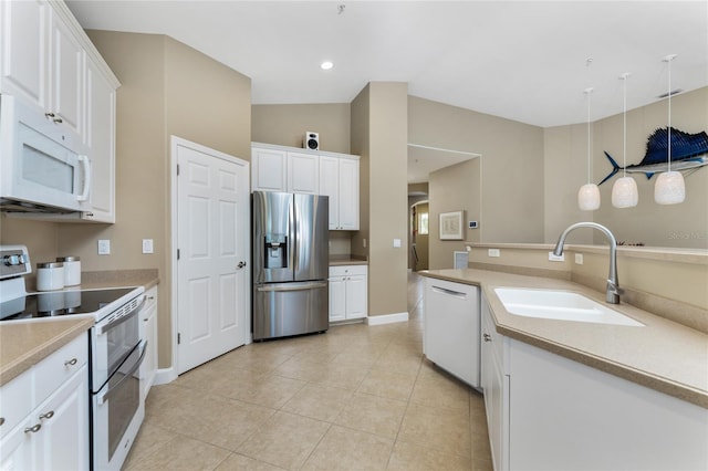 kitchen featuring light tile patterned floors, white appliances, a sink, white cabinetry, and light countertops