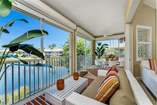 sunroom / solarium featuring a water view