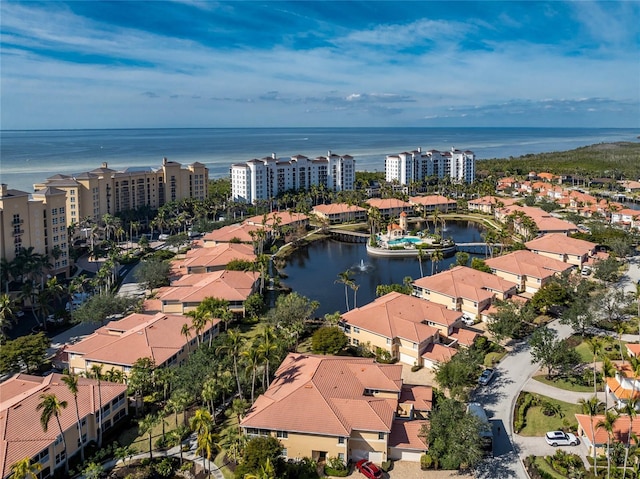 birds eye view of property featuring a water view and a city view