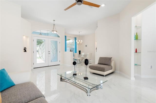 interior space with baseboards, marble finish floor, french doors, built in shelves, and ceiling fan with notable chandelier