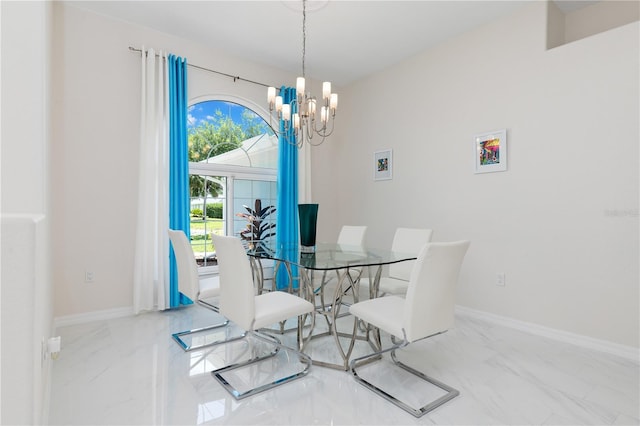 dining room featuring marble finish floor, baseboards, and an inviting chandelier