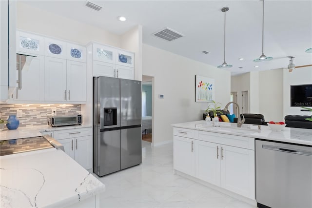 kitchen with visible vents, appliances with stainless steel finishes, white cabinets, and a sink