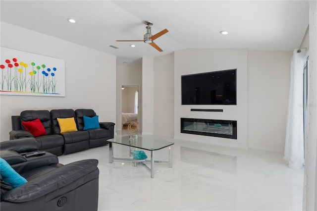 living room featuring recessed lighting, visible vents, vaulted ceiling, marble finish floor, and a glass covered fireplace