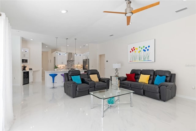 living area featuring recessed lighting, a ceiling fan, baseboards, visible vents, and marble finish floor