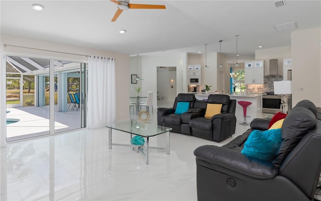 living area featuring recessed lighting, visible vents, and ceiling fan