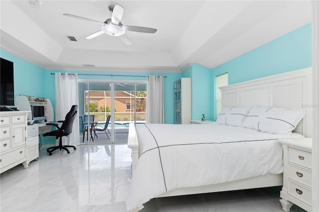 bedroom featuring access to outside, visible vents, a tray ceiling, and a ceiling fan