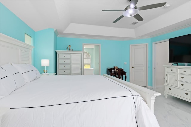 bedroom with a tray ceiling, marble finish floor, visible vents, and ceiling fan