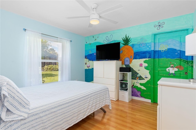 bedroom with ceiling fan and wood finished floors