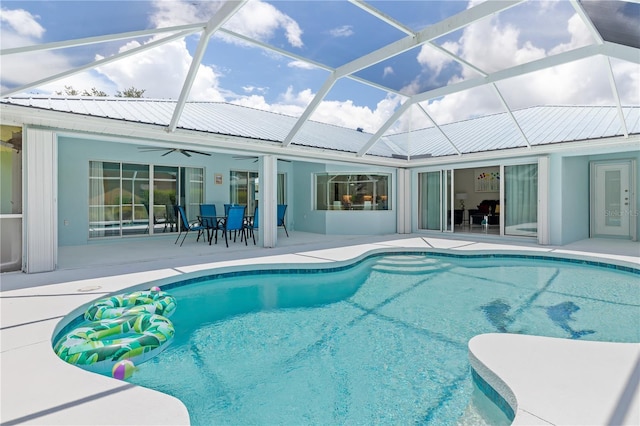 outdoor pool featuring a lanai, a ceiling fan, and a patio