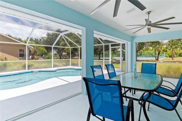 outdoor pool with glass enclosure, ceiling fan, and a patio