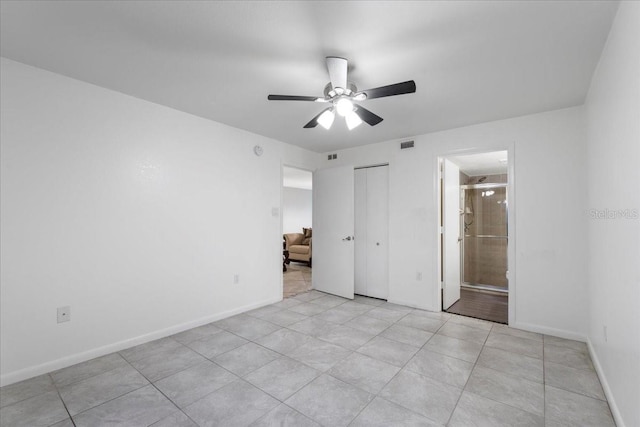 unfurnished bedroom featuring visible vents, baseboards, a closet, and ensuite bathroom