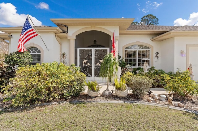 view of exterior entry featuring stucco siding