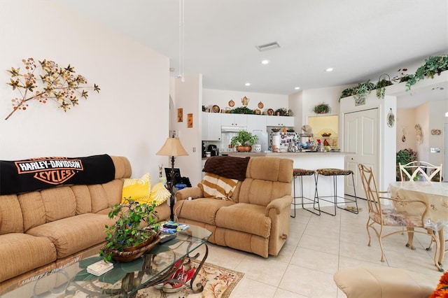 living area with recessed lighting, visible vents, and light tile patterned floors