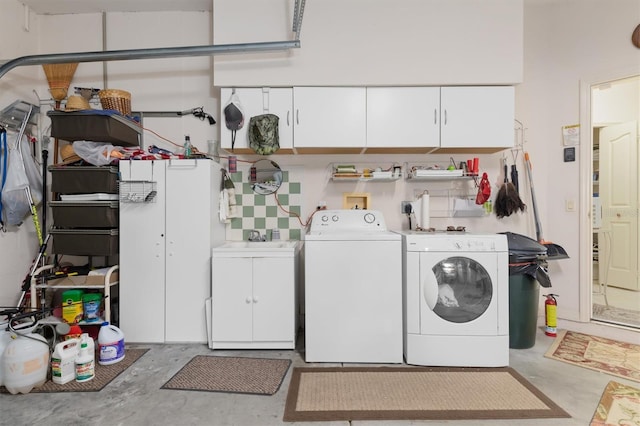 washroom with independent washer and dryer and cabinet space