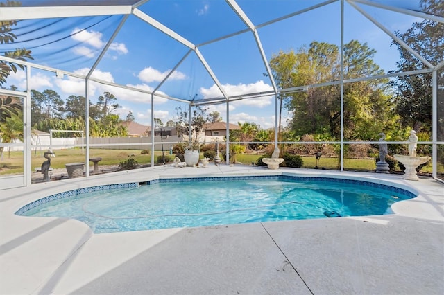 outdoor pool featuring glass enclosure, a patio, and fence