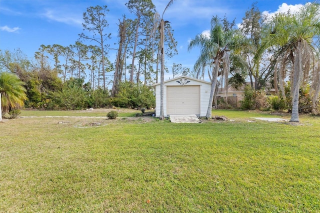 view of yard with a garage and an outdoor structure