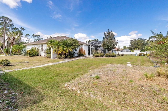 view of front of home with a front yard and a lanai