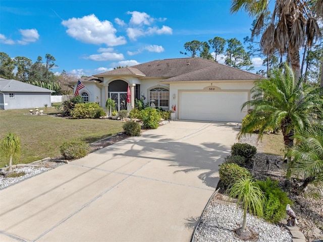 view of front of house featuring a garage, concrete driveway, a front lawn, and stucco siding