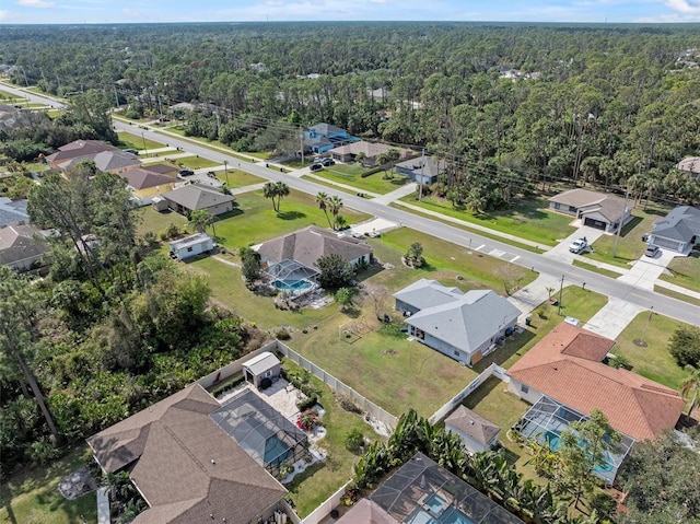 birds eye view of property featuring a residential view and a view of trees