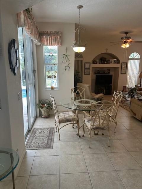 3816 N Cranberry Blvd, North Port, FL 34286 - dining room featuring light tile patterned floors, healthy amount of natural light, and ceiling fan