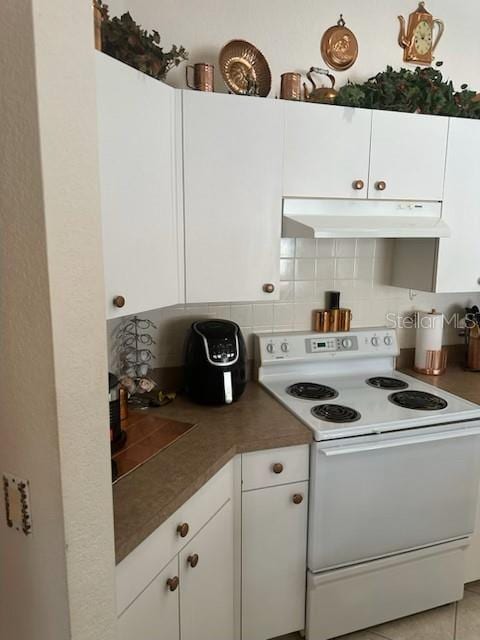 3816 N Cranberry Blvd, North Port, FL 34286 - kitchen featuring white electric range oven, under cabinet range hood, white cabinetry, and decorative backsplash