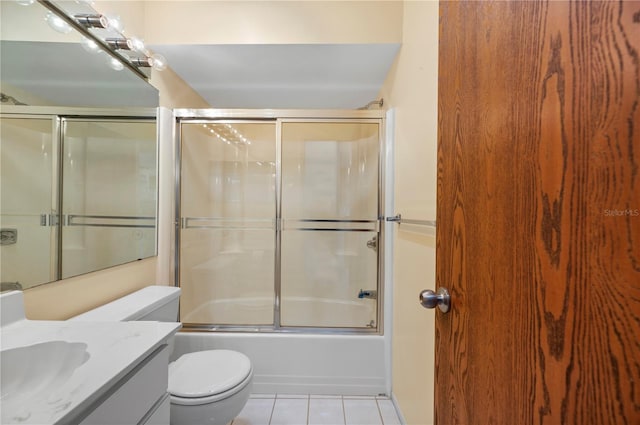 full bathroom featuring shower / bath combination with glass door, vanity, toilet, and tile patterned floors