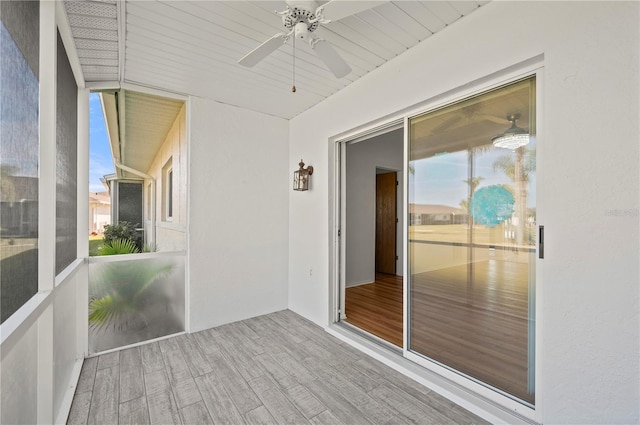 unfurnished sunroom featuring a ceiling fan